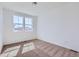 Empty bedroom with a cozy atmosphere, neutral carpet, and natural light from two windows at 712 N Bently St, Watkins, CO 80137