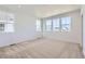 Bright bedroom with neutral carpet, ample natural light from multiple windows, and a spacious layout at 712 N Bently St, Watkins, CO 80137