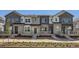 Modern townhome featuring varied neutral exterior color, stone accents, and inviting front porches at 712 N Bently St, Watkins, CO 80137