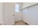 Walk-in closet with neutral carpet, a built-in clothes rack, and a window at 712 N Bently St, Watkins, CO 80137