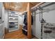 Organized walk-in closet with custom shelving, ample storage space, and hardwood floors at 1450 Wynkoop St # 3F, Denver, CO 80202