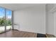 Bright living room featuring hardwood floors, a big window, and white walls at 3100 E Cherry Creek S Dr # 307, Denver, CO 80209