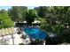 Community swimming pool with chairs and green surroundings at 3100 E Cherry Creek S Dr # 307, Denver, CO 80209