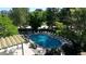 Community swimming pool with chairs and green surroundings at 3100 E Cherry Creek S Dr # 307, Denver, CO 80209