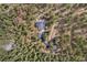 Birds eye view of a home surrounded by lush trees and a separate garage. Long driveway leading to a main road at 32173 Soda Creek Dr, Evergreen, CO 80439