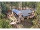 Aerial shot of home with solar panels on roof and outdoor deck area at 32173 Soda Creek Dr, Evergreen, CO 80439