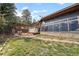 Spacious backyard featuring a pergola, outdoor seating, lush greenery and a home exterior at 32173 Soda Creek Dr, Evergreen, CO 80439
