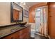 Stylish bathroom with a vessel sink, granite countertop, decorative mirror and walk-in shower at 32173 Soda Creek Dr, Evergreen, CO 80439