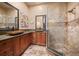 Bathroom features a stone walk-in shower, dual vessel sinks, granite countertops, and custom cabinetry at 32173 Soda Creek Dr, Evergreen, CO 80439