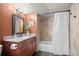 Charming bathroom features granite countertops, wood cabinets, a shower/bathtub, and modern fixtures at 32173 Soda Creek Dr, Evergreen, CO 80439