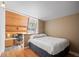 Bright bedroom featuring wood paneled wall, a dedicated desk area, and comfortable sleeping space at 32173 Soda Creek Dr, Evergreen, CO 80439