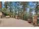 Spacious outdoor deck with stone accents and wooded views, perfect for entertaining or relaxing at 32173 Soda Creek Dr, Evergreen, CO 80439