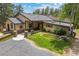 Stunning home with stone pillars, pond and lush landscaping, located on a beautiful large lot at 32173 Soda Creek Dr, Evergreen, CO 80439