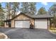 Detached two car garage with a pizza oven and paved driveway at 32173 Soda Creek Dr, Evergreen, CO 80439
