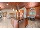 Open-concept kitchen with a view to the living room, hardwood floors, and a center island at 32173 Soda Creek Dr, Evergreen, CO 80439