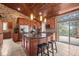 Well-appointed kitchen with a view to the backyard, stone tile floor, and black countertops at 32173 Soda Creek Dr, Evergreen, CO 80439