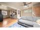 Comfortable living room featuring hardwood floors, a ceiling fan, and guitars hanging on the wall at 32173 Soda Creek Dr, Evergreen, CO 80439