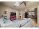 Inviting living room featuring an L-shaped sofa, a flat-screen TV, and a game arcade station at 32173 Soda Creek Dr, Evergreen, CO 80439