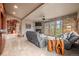 Bright and airy living room with a fireplace, expansive windows with backyard views, and comfortable seating at 32173 Soda Creek Dr, Evergreen, CO 80439
