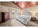 Spacious main bedroom featuring a coffered wood ceiling and a large bed with bedside tables at 32173 Soda Creek Dr, Evergreen, CO 80439