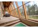 Bright sun room with wood beam construction, scenic windows, and a spa at 32173 Soda Creek Dr, Evergreen, CO 80439