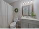 Clean bathroom features a shower with tub, fresh wreath, and wood-trimmed mirror at 1080 E 130Th Ave # A, Thornton, CO 80241