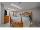 This furnished bedroom includes a wooden bed frame and shutters on the window at 1080 E 130Th Ave # A, Thornton, CO 80241