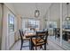 Bright dining room with a wood table, chic light fixture, and ample natural light from the large windows at 1080 E 130Th Ave # A, Thornton, CO 80241