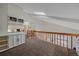 Second floor hallway with railing overlooking the living room and allowing natural light to filter in from below at 1080 E 130Th Ave # A, Thornton, CO 80241