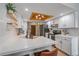 Modern kitchen with white cabinets, stainless appliances, open shelving, and stylish fixtures at 1080 E 130Th Ave # A, Thornton, CO 80241