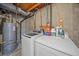A functional laundry room with modern washer, dryer and exposed mechanicals at 1080 E 130Th Ave # A, Thornton, CO 80241
