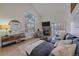 Bright living room featuring a fireplace, large windows, and comfortable seating area at 1080 E 130Th Ave # A, Thornton, CO 80241