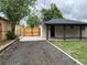A view of the backyard and newly renovated back patio with a covered area and privacy fence at 3210 Newport St, Denver, CO 80207