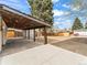 Expansive backyard featuring a covered patio, ample space, and a storage shed at 3210 Newport St, Denver, CO 80207