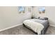 Cozy bedroom with neutral tones, plush carpeting, and two windows offering natural light at 3210 Newport St, Denver, CO 80207