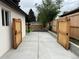 The freshly poured concrete driveway with gates on either side provides access to the backyard at 3210 Newport St, Denver, CO 80207