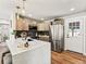 Modern kitchen with stainless steel appliances, quartz countertops, and ample cabinet space at 3210 Newport St, Denver, CO 80207
