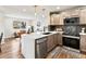 Stylish kitchen with quartz countertops, sleek appliances, and an open layout connecting to the living area at 3210 Newport St, Denver, CO 80207