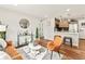 Cozy living room featuring stylish decor, wood floors, and an open concept layout to the kitchen at 3210 Newport St, Denver, CO 80207