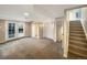 Spacious basement with carpet, access to the backyard, and a staircase to the main floor at 4901 Yates Ct, Broomfield, CO 80020