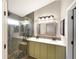 Modern bathroom featuring dual sinks, a glass enclosed shower and updated lighting at 4901 Yates Ct, Broomfield, CO 80020