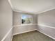 Empty bedroom with carpet, a large window, and neutral colored walls and trim at 4901 Yates Ct, Broomfield, CO 80020