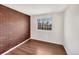 Modern bedroom featuring hardwood floors and an exposed brick accent wall at 4901 Yates Ct, Broomfield, CO 80020