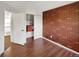 Charming bedroom featuring hardwood floors, a brick accent wall and a closet with shelving at 4901 Yates Ct, Broomfield, CO 80020