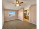 Spacious bedroom featuring a ceiling fan, carpeted floors and ensuite bath with a modern vanity at 4901 Yates Ct, Broomfield, CO 80020