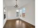 Sun-filled dining room with hardwood floors, modern chandelier, and views of the neighborhood at 4901 Yates Ct, Broomfield, CO 80020