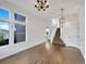 Bright entryway featuring wood floors, large windows, a modern chandelier, and staircase to the second floor at 4901 Yates Ct, Broomfield, CO 80020
