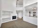 Open-concept living room with fireplace, built-in shelves, and views of the staircase at 4901 Yates Ct, Broomfield, CO 80020