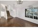 Living room featuring wood floors, a staircase, chandelier, and large windows at 4901 Yates Ct, Broomfield, CO 80020