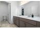 Bright bathroom featuring double sink vanity, large mirror, and white trim at 3015 Pershing St, Strasburg, CO 80136
